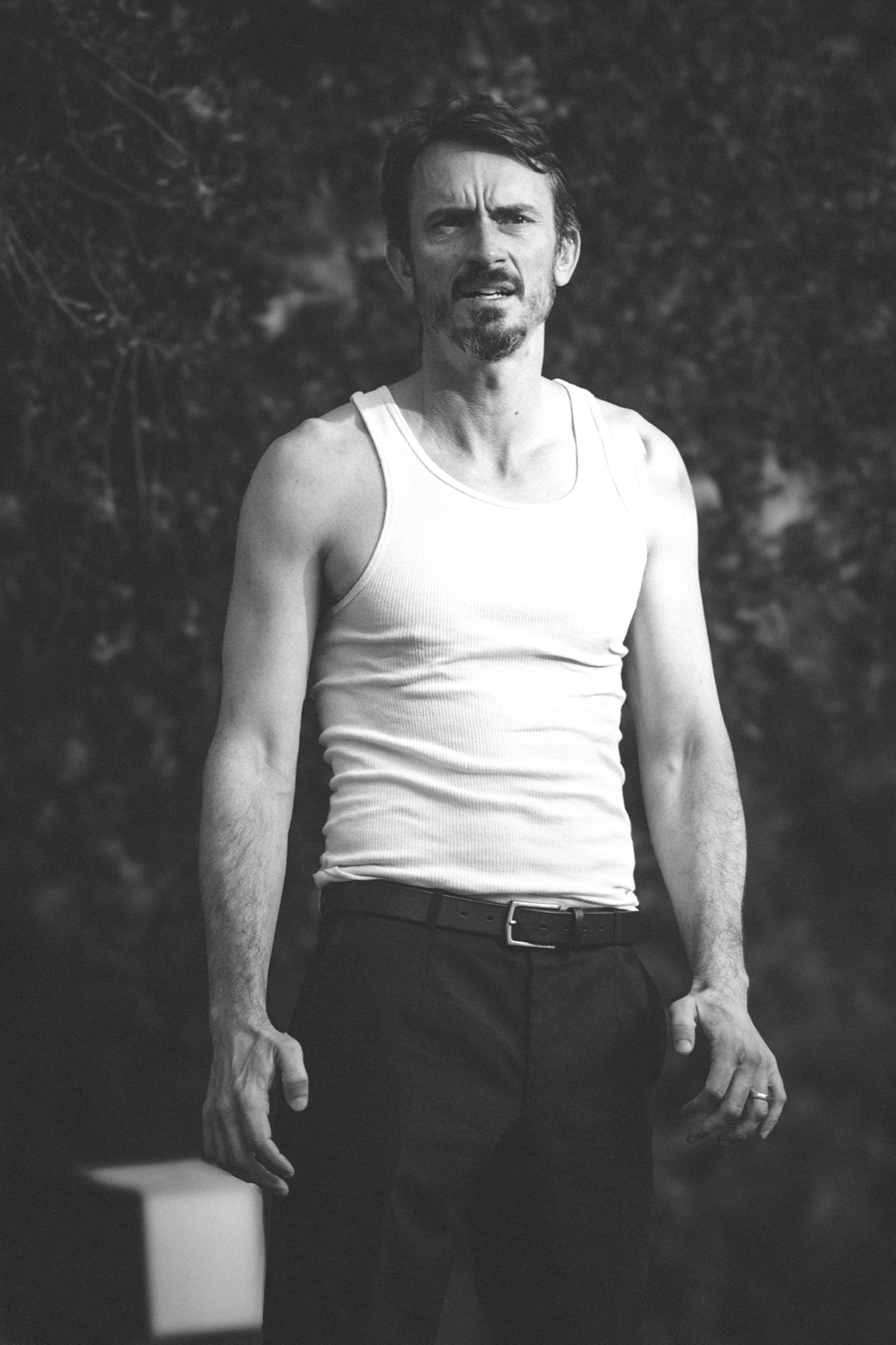 Luke Edwards headshot — undershirt, full-length standing